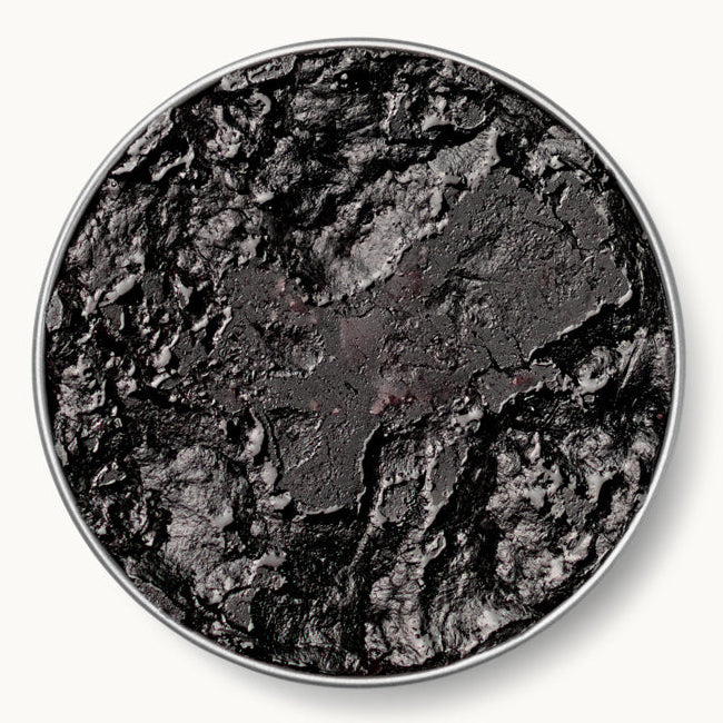 Caviar Russe pressed caviar — dense, jam-like texture with a deep, concentrated flavor, in a tin